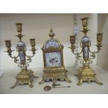 A mid 20thC Continental cast brass and ceramic cased clock garniture,