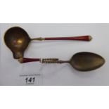 A Norwegian silver gilt and red enamel crucible and scrolled spoon stamped 925 in a presentation