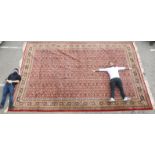 A Persian carpet profusely decorated with flora and other stylised designs on a multi-coloured
