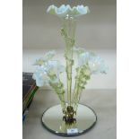 A late Victorian vaseline glass epergne, comprising a central and four smaller frilled trumpets,