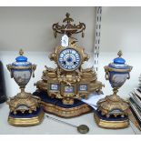 A late 19thC French gilded spelter cased mantel clock with inset, floral painted porcelain panels,