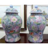 A pair of modern Chinese vases of baluster form, decorated with flora,