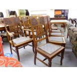 A set of seven early 20thC mahogany framed dining chairs with stylised foliate carved tablet and