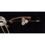 An 'antique' rose gold coloured metal clover leaf bar brooch, set with three diamonds,