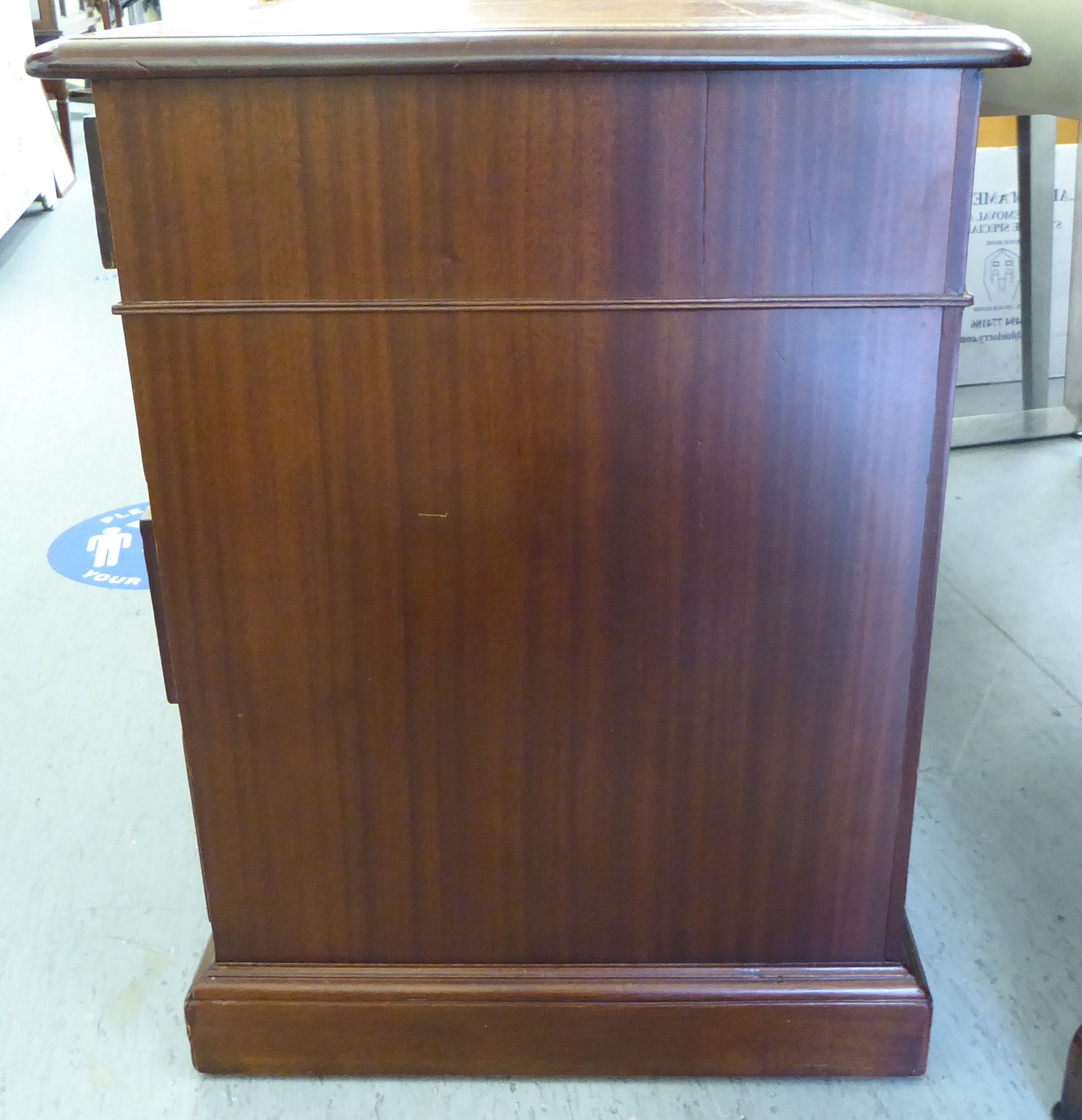 An early 20thC mahogany desk, the top set with a tooled brown hide scriber, - Image 3 of 6