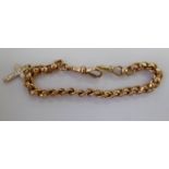 A 9ct gold bracelet with a crucifix pendant charm 11