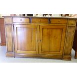 A modern French satinwood finished sideboard, comprising three inline drawers,