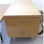A pair of modern maple finished, two drawer bedside chests, raised on turned feet 21''h 19.
