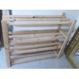 A modern pine three tier shoe rack of planked construction 28''h 32''w F