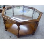 A modern coffee table, the inset glass top in a beech framed octagonal top,