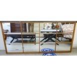 A 'vintage' teak framed twelve section mirror 29'' x 63'' BSR