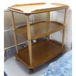 An Ercol beech and elm galleried, three tier tea trolley,