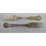 A matched pair of Victorian silver oyster back table forks mixed London marks 11