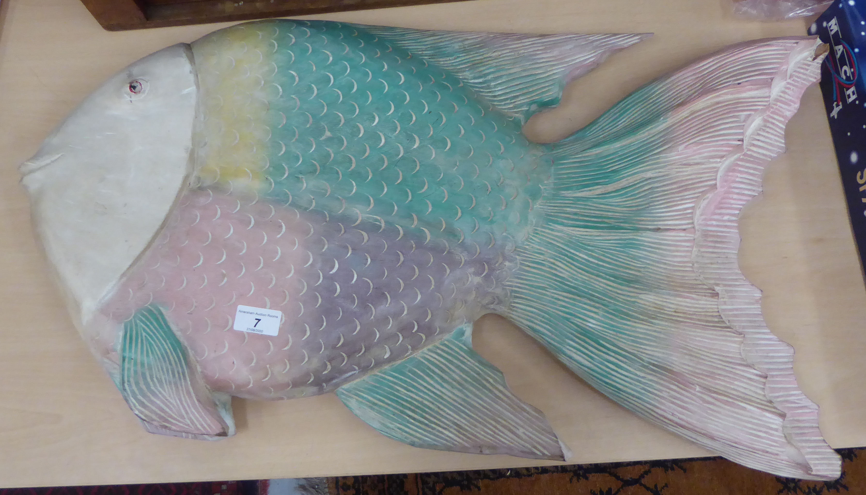 A modern carved wooden wall plaque, in the form of an Angel fish,