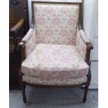 A modern stained beech framed armchair, the floral patterned fabric upholstered back,