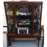 An Edwardian fully glazed mahogany display cabinet, enclosed by a full-height central door,