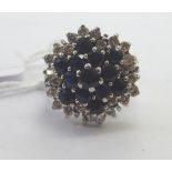 An 18ct white gold sapphire and diamond cluster ring 11