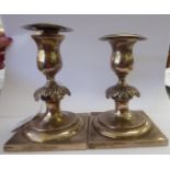 A pair of Continental white metal dwarf candlesticks,