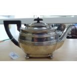 A Georgian style silver teapot of oval, bulbous form with embossed wire ornament, a swept spout,