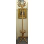 A modern light stained beech, bentwood style, freestanding hat and coat rack,