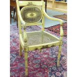 An early 20thC Regency style cream painted elbow chair,