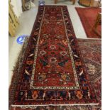 A Persian runner, decorated with geometric stylised designs,