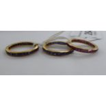 Three similar gold coloured metal eternity rings,