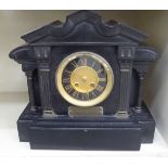An Edwardian black slate cased mantel clock of architectural form;