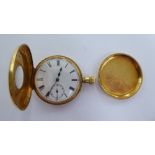 An 18ct gold half hunter pocket watch with enamelled blue Roman numerals around the window,