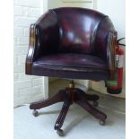 A 20thC Georgian style part stud and hide upholstered, tub design desk chair,