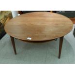 A France & Son, Danish made, teak coffee table, the top with a rounded edge, raised on plain turned,