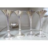 A set of four Edwardian silver specimen vases with frilled, quatrefoil outlined rims,