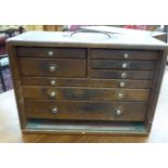 A mid 20thC teak Union tool chest with a removable front panel,