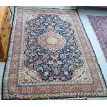 A Persian carpet with a stylised floral border and additional ornament,
