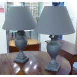 A pair of modern composition table lamps of pedestal vase design, on a stepped,