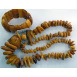 An irregularly cut amber coloured beaded necklace and bracelet 11