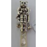 A Victorian style Sterling silver baby's rattle, featuring a cat with a mop,
