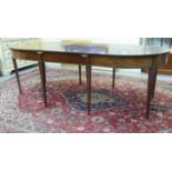 An early 19thC mahogany double D-end dining table with a straight apron and an additional central