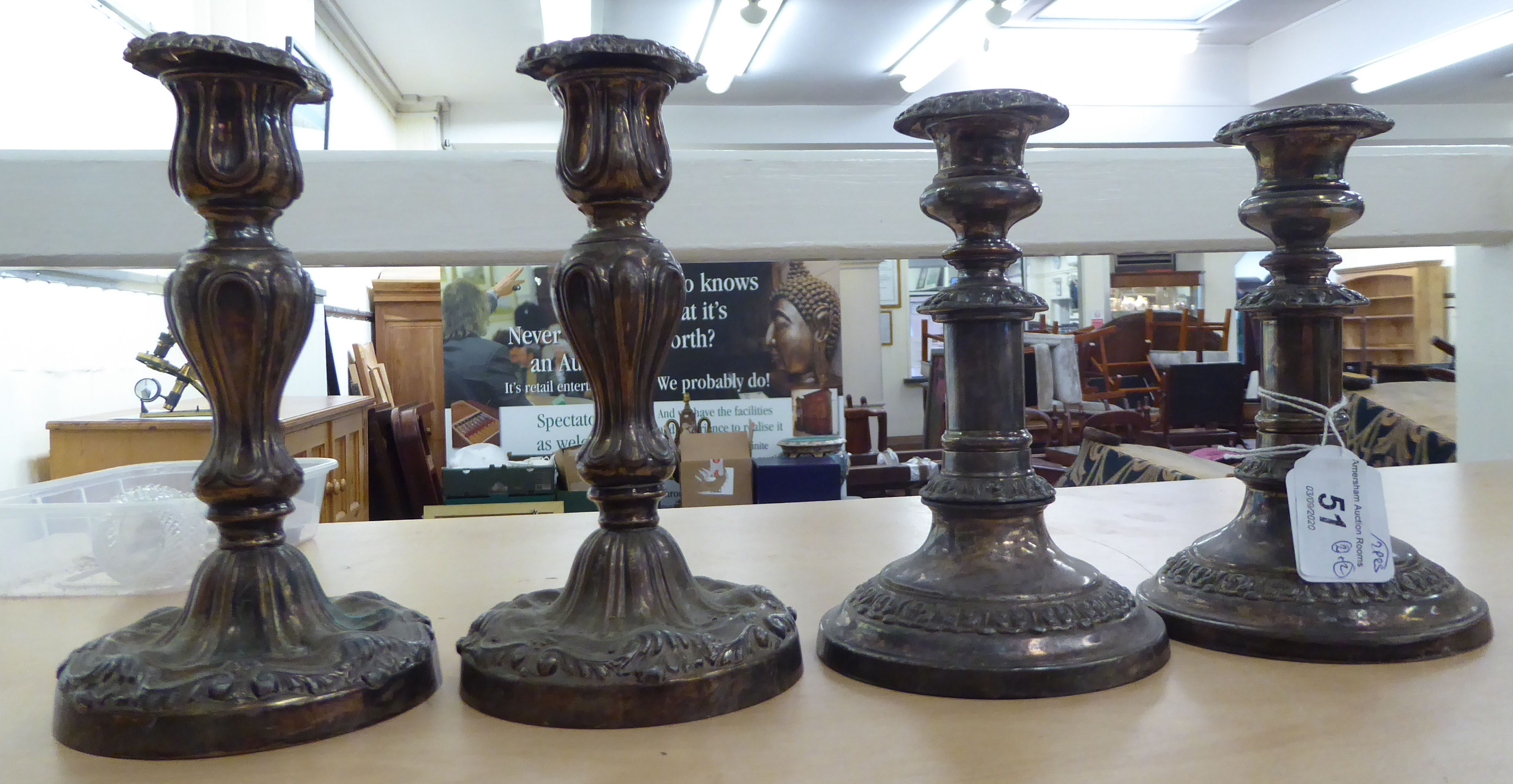 A pair of 19thC silver plated telescopic candlesticks with cast C-scrolled border ornament,