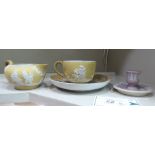 A Wedgwood sand coloured Jasperware coffee cup, saucer and cream jug,