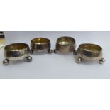 A set of four silver circular salt cellars,