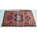 A Persian rug, decorated with stylised designs,