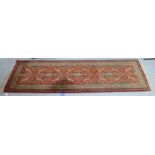A Persian runner, decorated with stylised foliage designs,