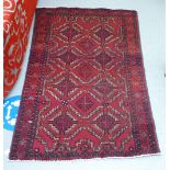 A Turkoman rug, decorated with two columns of four diamond motifs, bordered by stylised designs,