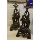 A pair of modern Chinese, cast metal fire dogs,