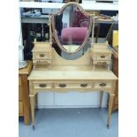 An early 20thC bleached pine dressing table, surmounted by a mirror and two box drawers,