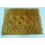 A Turkoman rug, decorated with a column of three octagonal guls,
