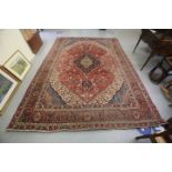 A Persian carpet, profusely decorated with stylised foliage and other designs,