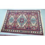 A Caucasian rug, decorated with stylised designs,