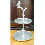 A modern cast metal table centrepiece, fashioned as a bird perched on a branch,